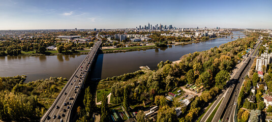 Aerial view on a sunny ,autumn day on the center of Warsaw ,skyscrapers ,financial centers and the Vistula River and bridges on it.