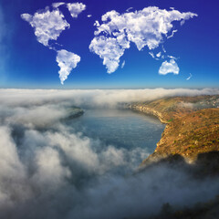 clouds in the form of a world map over the river canyon. conceptual landscape. autumn morning