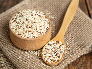 mixed raw quinoa in bowls on a wooden background. Healthy and gluten free food.