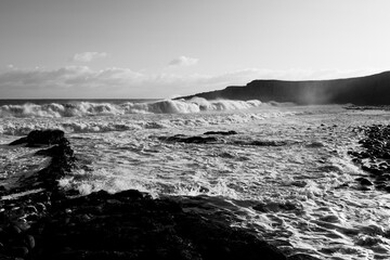 Crashing waves on a large rock formation