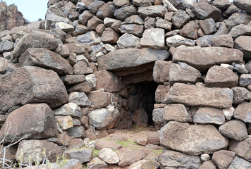 Fototapeta na wymiar A hut built of stones. The stones are gray in color.
