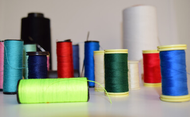 spools of thread and needle, colorful background