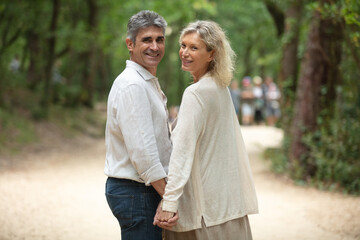 Obraz premium cute middle aged couple embracing outdoors