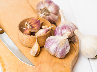 garlic. garlic clove, flask of garlic in a wooden bowl on a wooden background.Healthy food concept.