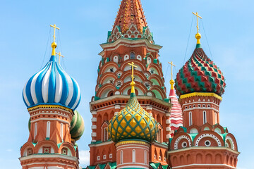 Fototapeta na wymiar Colored domes of St. Basil's Cathedral against the blue sky. Close-up