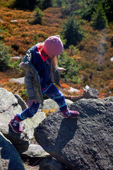 Child on the rock in the mountains