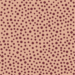 Cute pattern of dots of different shapes on a beige background