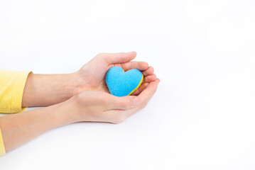 Heart in hands. The heart is blue-yellow. Flag of Ukraine. On a white background