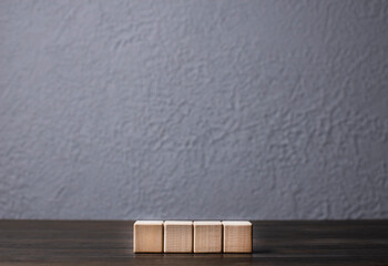 4 Cubes on the table. Wooden blocks. Numeric