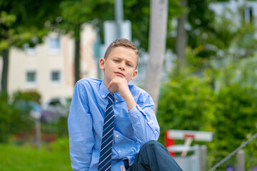 boy in blue shirt thinks for a better world