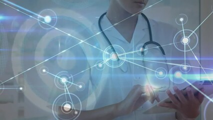 Animation of connected dots and dartboard over caucasian female doctor using digital tablet - Powered by Adobe
