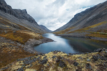 Blue northern lake in harsh mountains in north