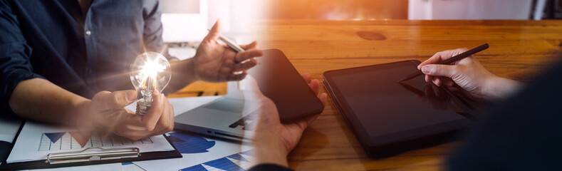Fototapeta premium Business team present. professional investor working new start up project. Finance managers meeting.Digital tablet docking screen computer design smart phone using, in morning light