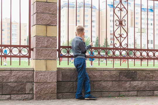 A Little Boy Watches The Stadium