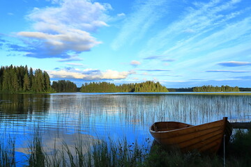 One old wooden rowing boat. At a calm Swedish summer lake. No oil or engine. Jämtland, Sweden,...