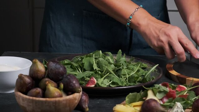 women's hands make fresh salad