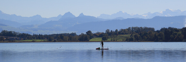 Fototapeta na wymiar Stand up paddling on Lake Pfaeffikon.