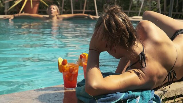 two girls in a bikini at the pool