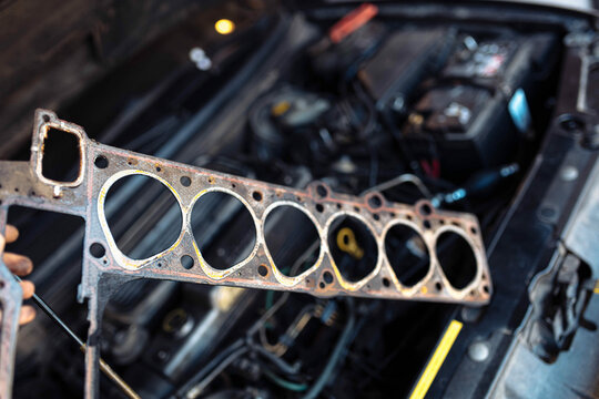 concept of replacing the cylinder head gasket on a car engine. Laying of the six-cylinder engine.