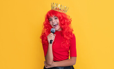 girl smile in crown with microphone on yellow background