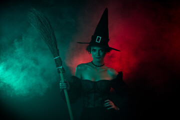 Photo of stunning lady warlock holding broom stick witch carnival preparation isolated on vibrant...