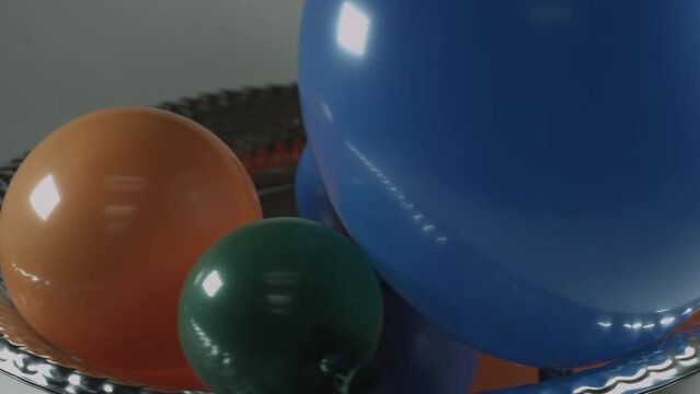 Multicolor Balloons Slowly Rotate on Metallic Platter 4K