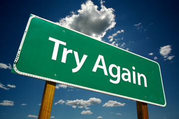 Try Again Green Road Sign On Cloudy Blue Sky Background