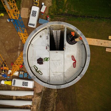 Top view of a windmill construction site with various equipment on a sunny day