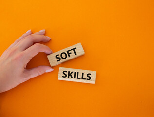 Soft skills symbol. Wooden blocks with words Soft skills. Beautiful orange background. Businessman...