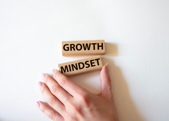 Growth Mindset symbol. Concept word Growth Mindset on wooden blocks. Beautiful white background. Businessman hand. Business and Growth Mindset concept. Copy space