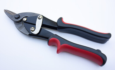 Scissors on metal on white isolate. A hand tool for cutting tin metal. Cut the iron sheet with scissors.