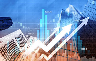 As background for a financial or business concept, digital screen and financial graphs overlap on a picture of modernistic cityscape, skyscrabbers.