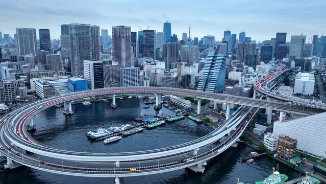 Tokyo aerial cityscape, busy traffic at urban intersection in Tokyo, Japan, suspension bridge and skyscrapers in Tokyo harbour