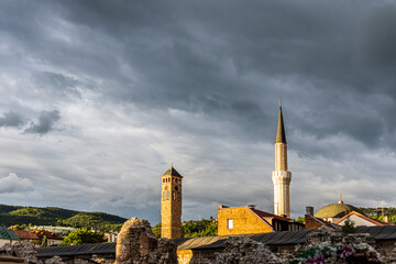 Sarajevo clock tower and minaret of Gazi Husrev bey mosque with taslihan remains and roof of bezistan. Famous historical touristic plac visit located at center of Bascarsija in capital city