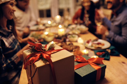 Close up of gift boxes at dining table during Christmas dinner party.