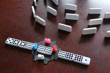 Mexican train game and dominos. Dark table. Board game with tiles. Close up and isolated.