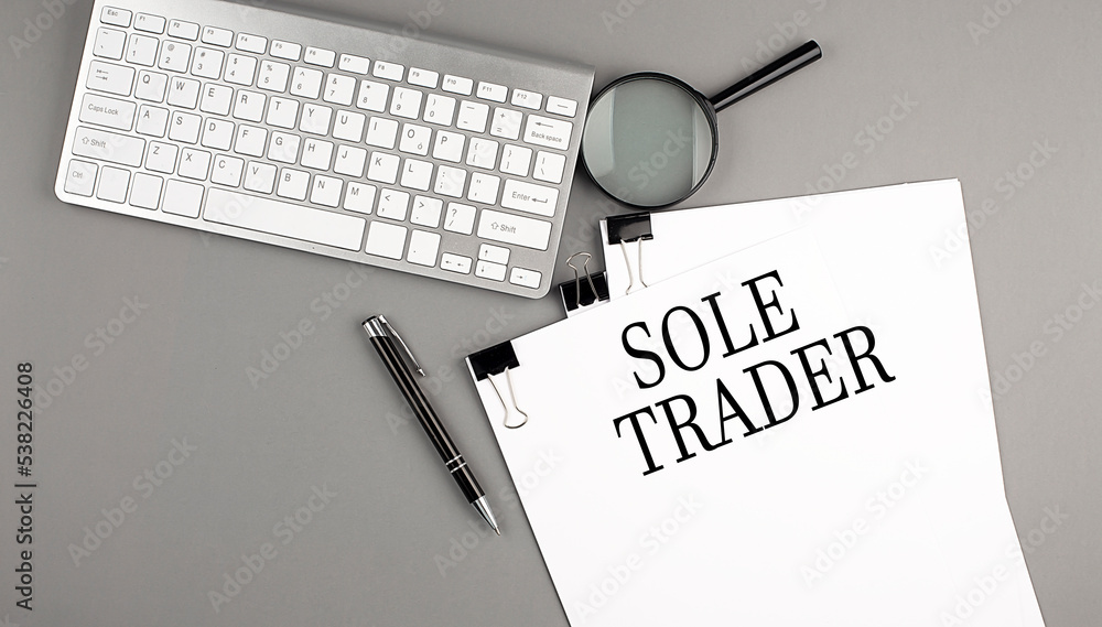 Poster sole trader text on paper with keyboard, magnifier and pen. business concept