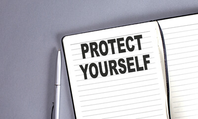 PROTECT YOURSELF word on the notebook with pen