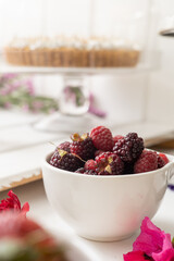fresh red berries on a plate, healthy food and ingredient in studio, strawberries and blackberries, nutritious diet