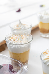 delicious coffee appetizers in glass cups with cream and cinnamon, desserts with elegant decoration, studio, pastry shop