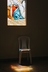 interior of a room with a chair, stained glass window in church
