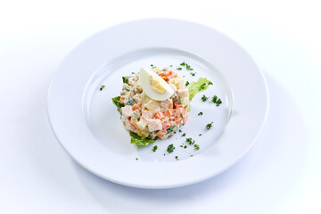 traditional russian salad on white plate