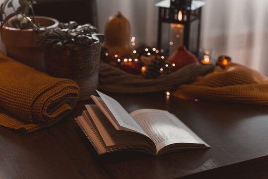 autumn photo on table with candles reading a book