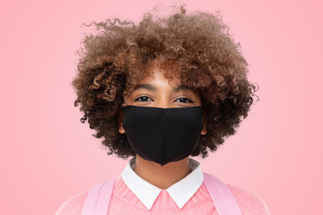 Headshot of african american college student girl with curly afro hair wearing black cotton mask