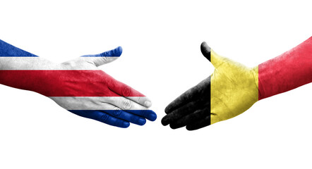 Handshake between Belgium and Costa Rica flags painted on hands, isolated transparent image.