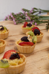 sweet snacks decorated with fruits and cream, appetizers for catering service, studio with fresh and delicious food