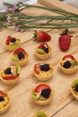 sweet appetizers decorated with fruits and cream, catering service, studio with fresh and delicious food, wallpaper