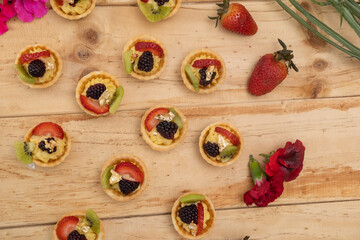 delicious sweet appetizers decorated with tropical fruits and cream, catering service, studio with fresh and delicious food, table wallpaper