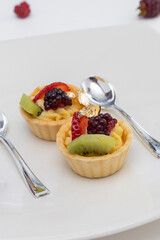 gourmet style served with sweet dessert and spoons, food decorated with fruits and cream, wallpaper and elegant lifestyle, delicious dessert