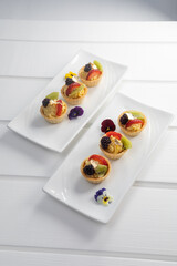 delicious appetizers arranged on plates, gourmet food decorated with fruits, sweet dessert wallpaper, pastries